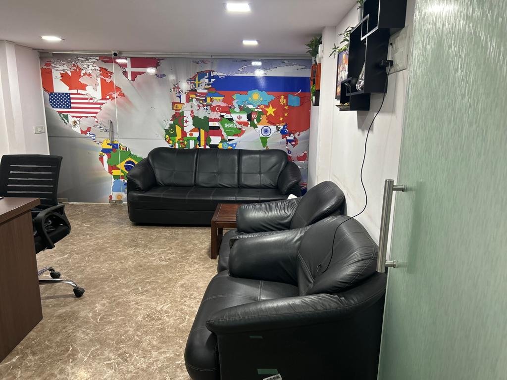 The client lounge at the DreamWings office, with a world flag mural